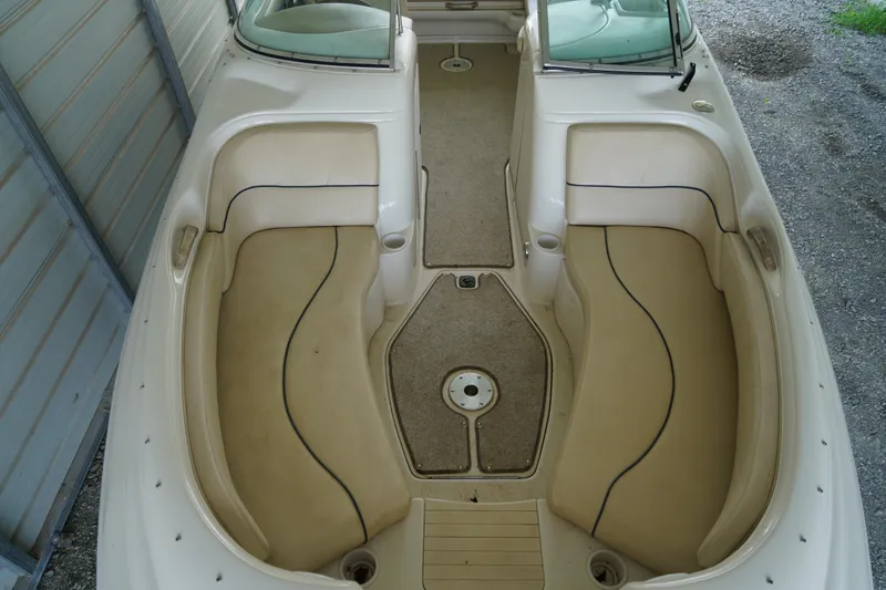 Slide: The Image of 2000 Sea Ray 210 Sundeck interior with beige seating and carpeted floor. - 17