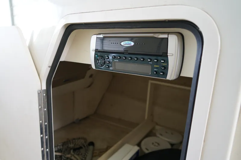 Slide: The Image of Interior of a 2000 Sea Ray 210 Sundeck featuring a Clarion stereo system. - 18