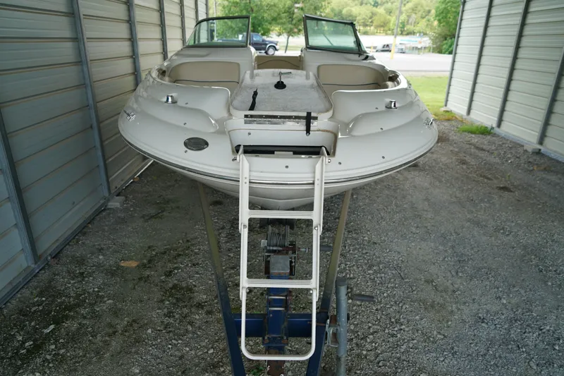 Slide: The Image of 2000 Sea Ray 210 Sundeck boat on trailer in covered storage area. - 2