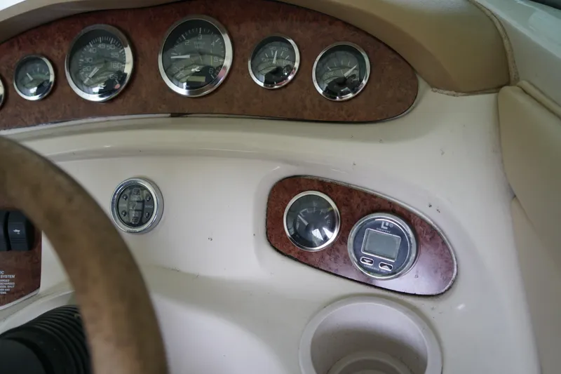 Slide: The Image of Dashboard of a 2000 Sea Ray 210 Sundeck boat with gauges and controls. - 11