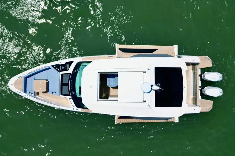 Slide: The Image of Aerial view of 2027 Saxdor 400 GTC boat on green water. - 20