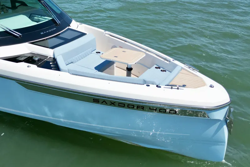 Slide: The Image of 2027 Saxdor 400 GTC boat on water, featuring sleek design and spacious seating area. - 13