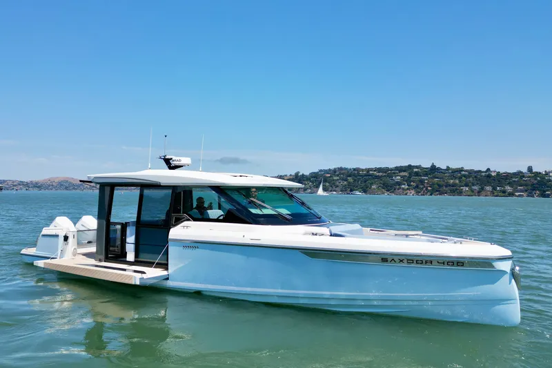 The Image of 2027 Saxdor 400 GTC boat cruising on a sunny day in scenic waters. - 0