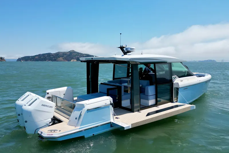 Slide: The Image of 2027 Saxdor 400 GTC luxury boat cruising on open water with scenic island backdrop. - 2