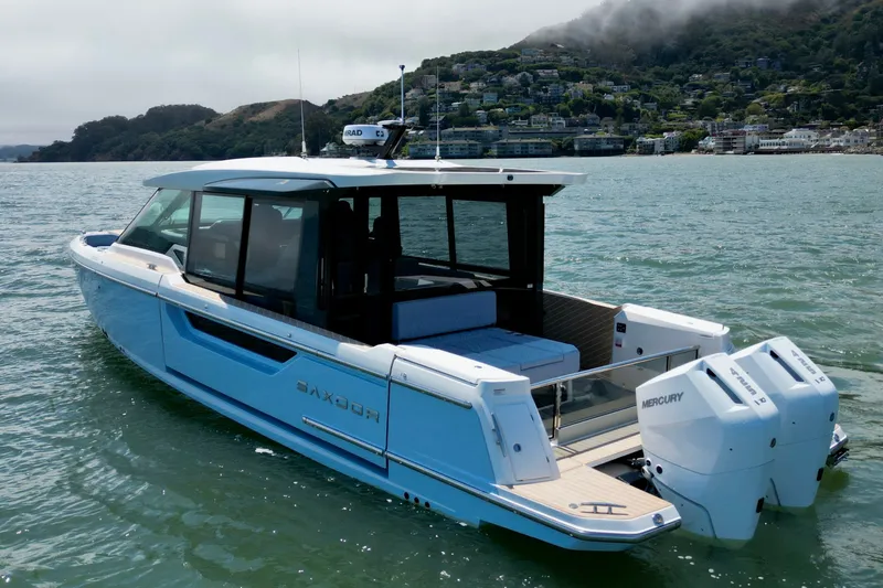 Slide: The Image of 2027 Saxdor 400 GTC boat on water, featuring sleek design and dual Mercury engines. - 6