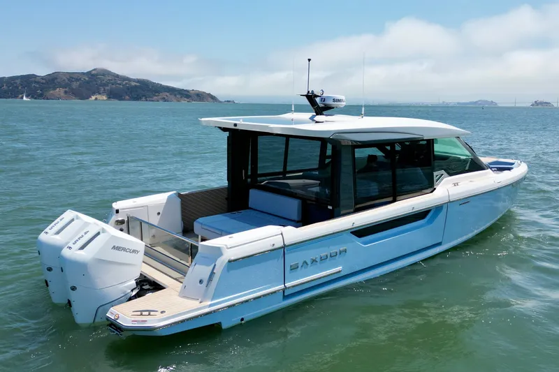 Slide: The Image of 2027 Saxdor 400 GTC boat on water, featuring sleek design and twin Mercury engines. - 9