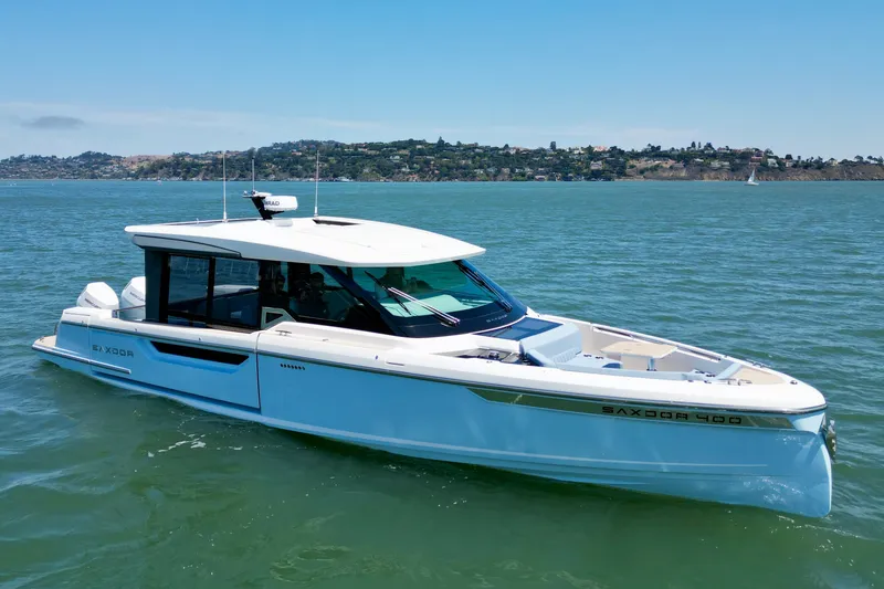 Slide: The Image of 2027 Saxdor 400 GTC luxury yacht cruising on a serene lake under a clear blue sky. - 12
