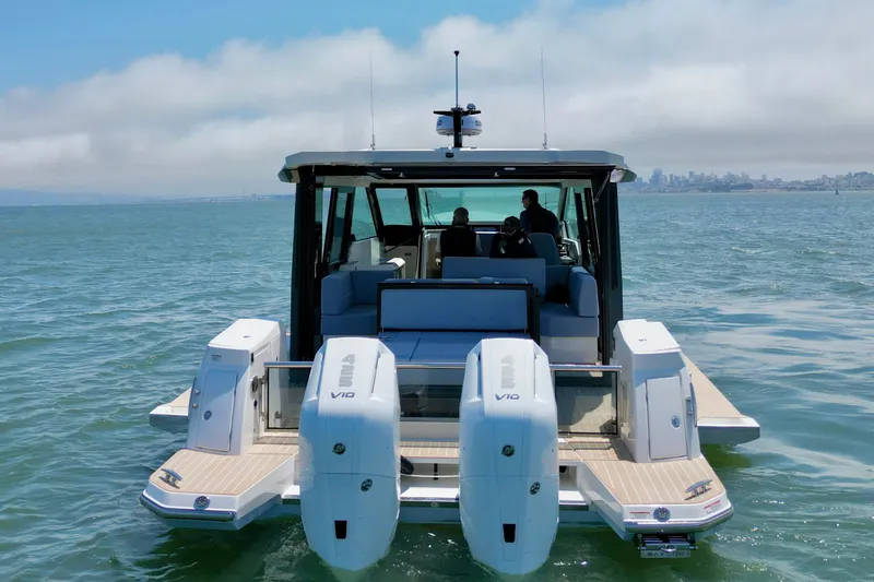 Slide: The Image of 2027 Saxdor 400 GTC boat cruising on open water with twin engines. - 8