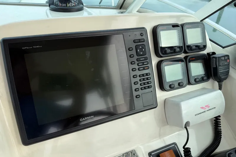 Slide: The Image of Control panel of a 2006 Pursuit 2570 Offshore boat with Garmin GPS and gauges. - 10