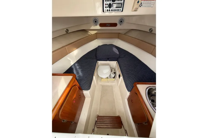 Slide: The Image of Interior of 2006 Pursuit 2570 Offshore boat with seating, sink, and storage. - 19