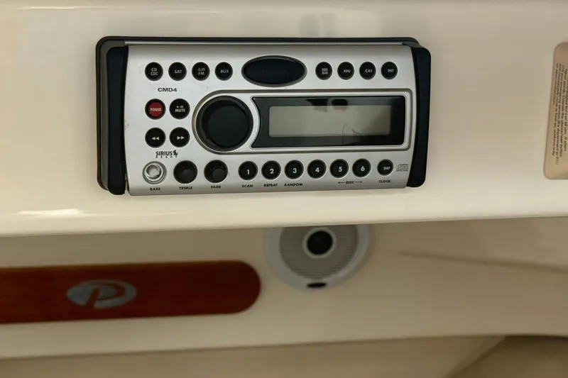 Slide: The Image of 2006 Pursuit 2570 Offshore boat stereo system with control panel and speaker. - 20