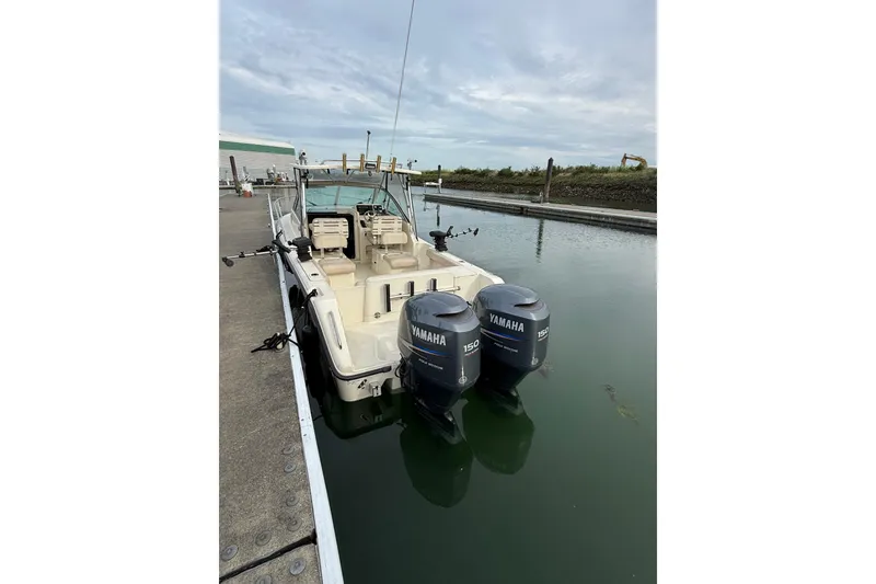 Slide: The Image of 2006 Pursuit 2570 Offshore boat docked with twin Yamaha engines. - 23