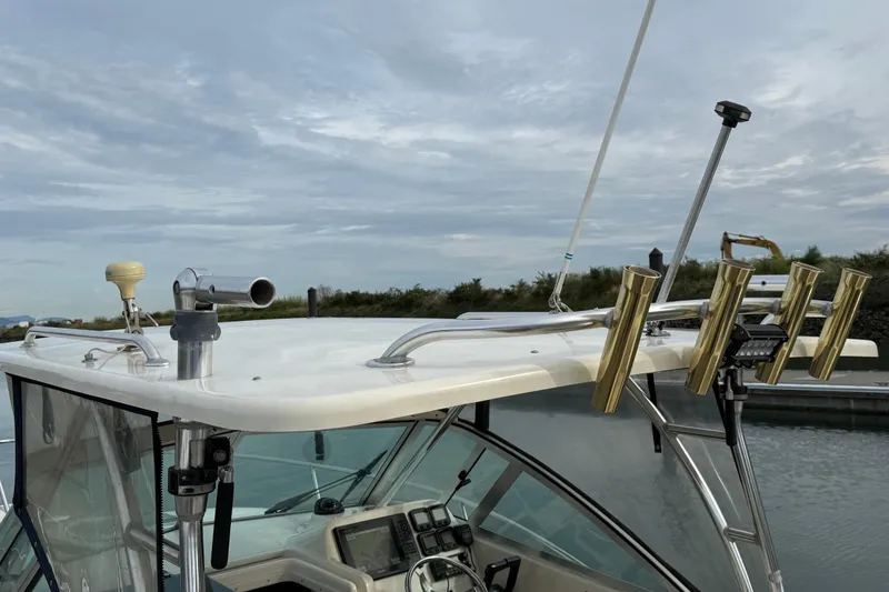 Slide: The Image of 2006 Pursuit 2570 Offshore boat with fishing rod holders and navigation equipment. - 30