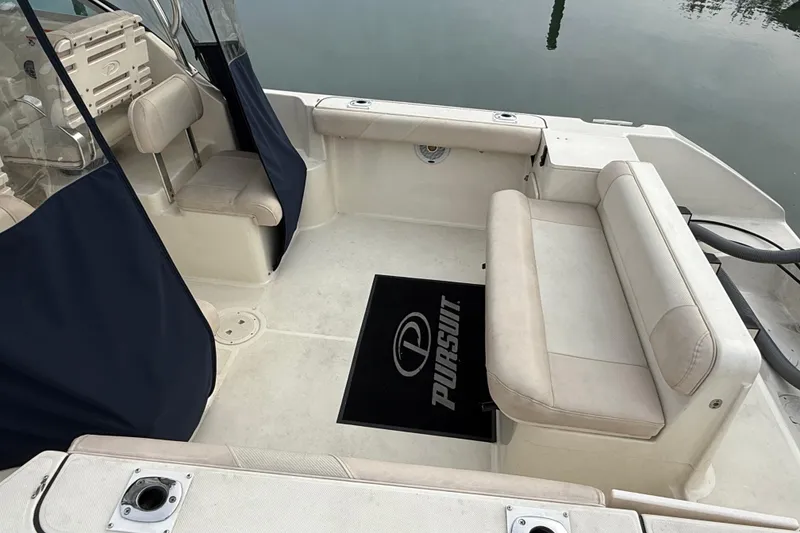 Slide: The Image of 2006 Pursuit 2570 Offshore boat interior with seating and branded mat. - 8