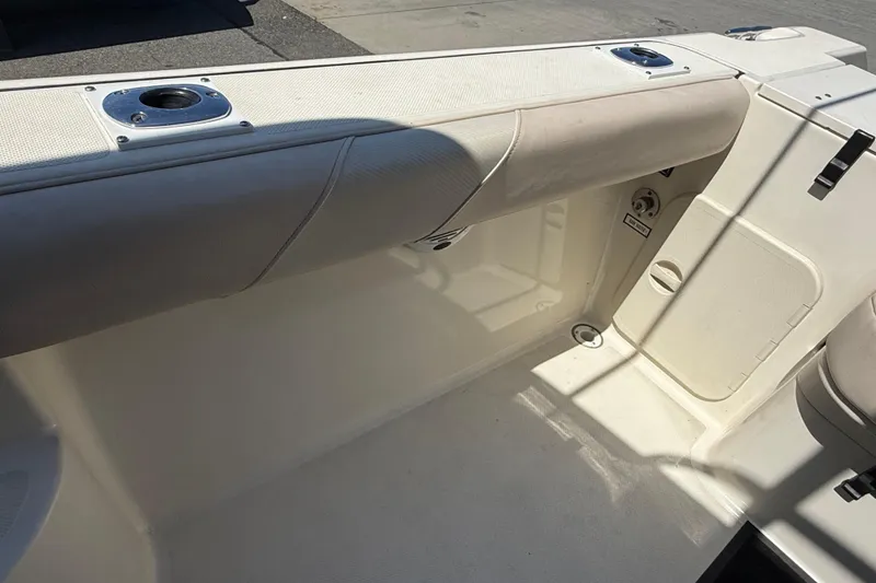 Slide: The Image of 2007 Pursuit 2570 Offshore boat interior with cushioned seating and rod holders. - 25