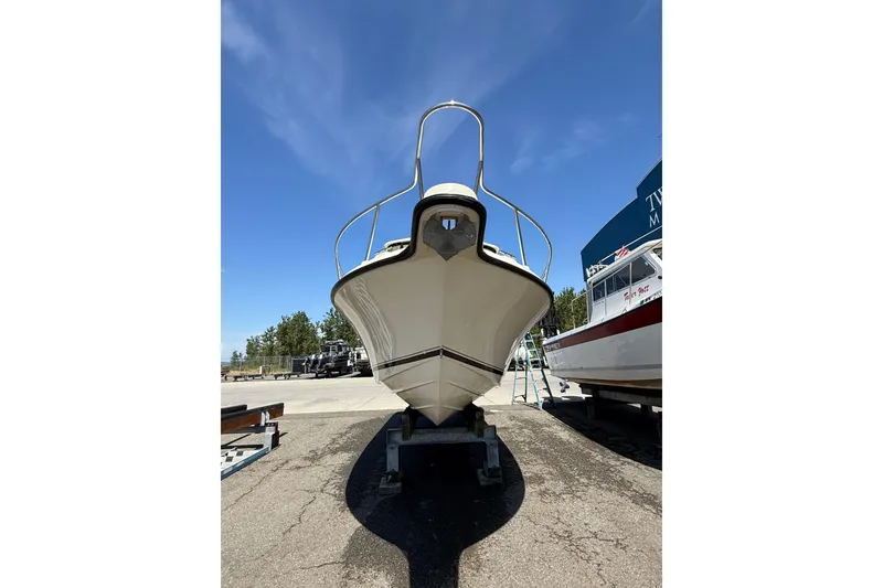 Slide: The Image of 2007 Pursuit 2570 Offshore boat on trailer under clear blue sky. - 52