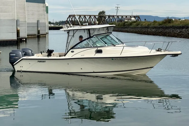 Slide: The Image of 2006 Pursuit 2570 Offshore boat with twin Yamaha engines on calm water. - 1