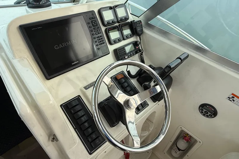 Slide: The Image of 2006 Pursuit 2570 Offshore boat helm with Garmin navigation system and control panel. - 11