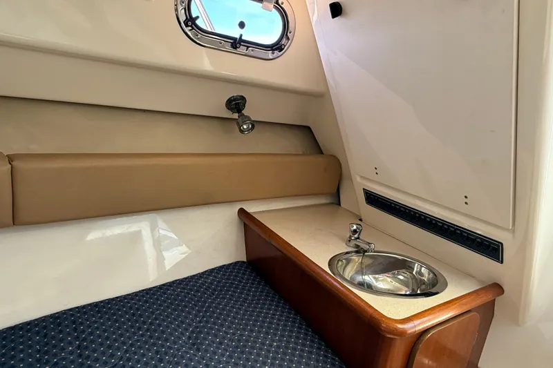 Slide: The Image of Interior cabin of 2007 Pursuit 2570 Offshore boat with sink and porthole. - 41