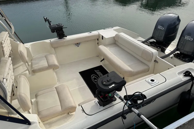 Slide: The Image of 2006 Pursuit 2570 Offshore boat interior with seating and dual Yamaha 150 engines. - 21