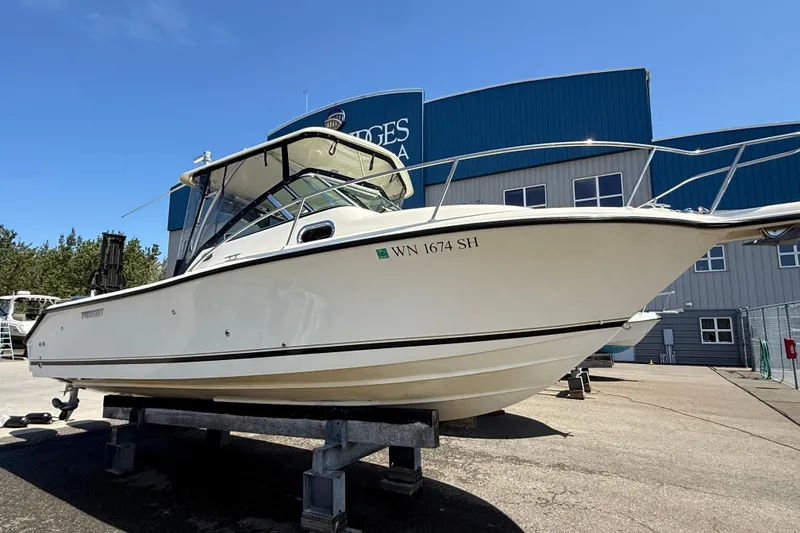 Slide: The Image of 2007 Pursuit 2570 Offshore boat on display outside a marina building. - 0