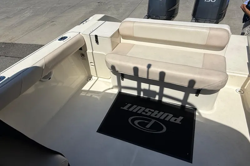Slide: The Image of 2007 Pursuit 2570 Offshore boat interior with seating and twin outboard engines. - 24