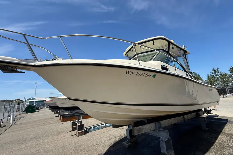 Slide: The Image of 2007 Pursuit 2570 Offshore boat on dry dock under clear blue sky. - 55