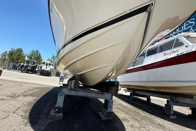 Slide: The Image of 2007 Pursuit 2570 Offshore boat on stands in a marina, clear sky background. - 53