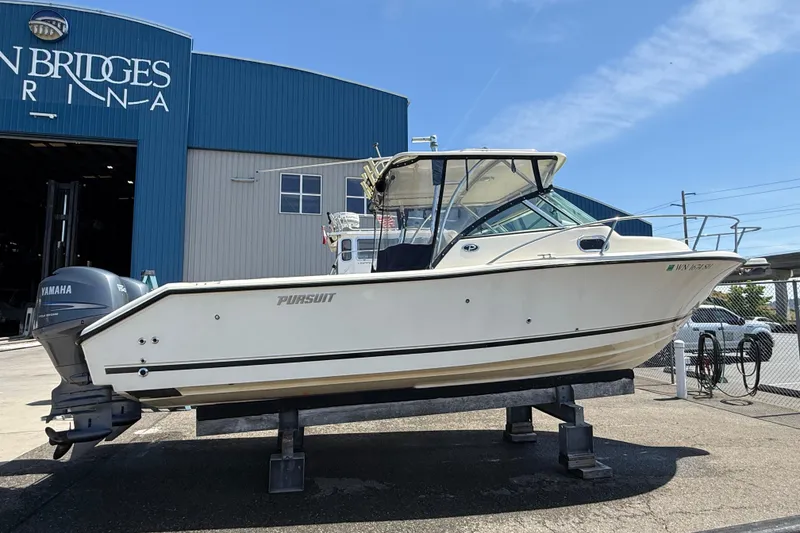 Slide: The Image of 2007 Pursuit 2570 Offshore boat on display at a marina with Yamaha engines. - 50