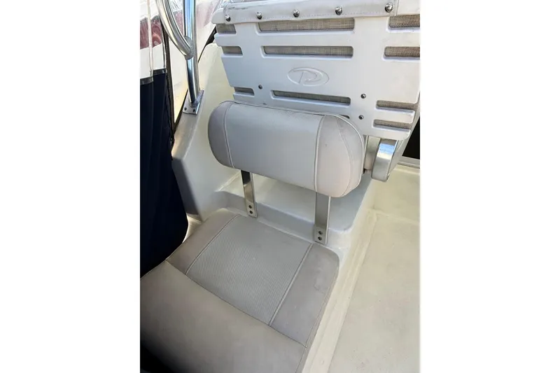 Slide: The Image of 2007 Pursuit 2570 Offshore boat seat with padded backrest and metal support. - 48