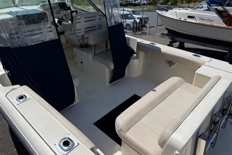 Slide: The Image of 2007 Pursuit 2570 Offshore boat interior with seating and steering area. - 21