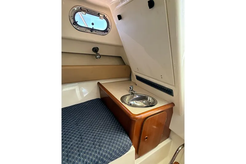 Slide: The Image of Interior of 2007 Pursuit 2570 Offshore boat with sink and porthole window. - 42