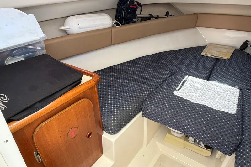 Slide: The Image of Interior cabin of a 2007 Pursuit 2570 Offshore boat with cushioned seating. - 16