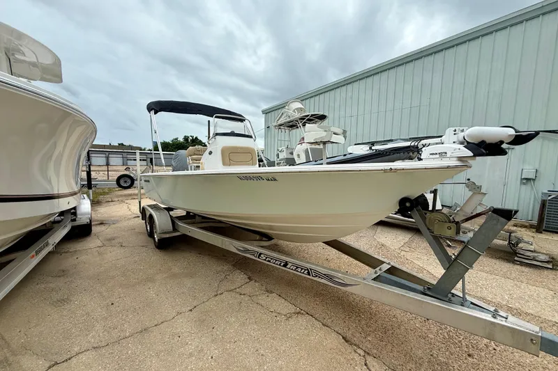 Slide: The Image of 2015 Sportsman Masters 227 Bay Boat on trailer, parked outdoors near a building. - 1