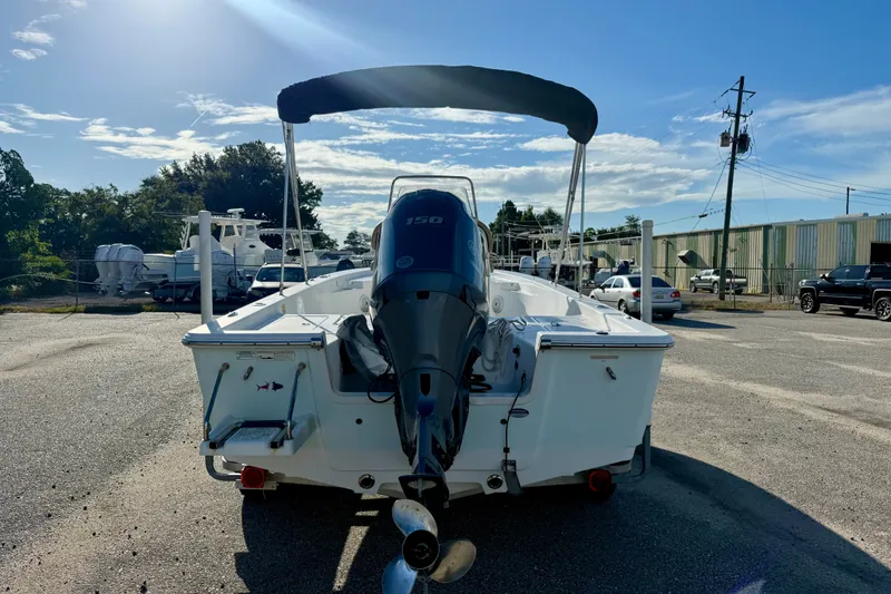 Slide: The Image of 2015 Sportsman Masters 227 Bay Boat with outboard motor, parked outdoors under clear sky. - 3