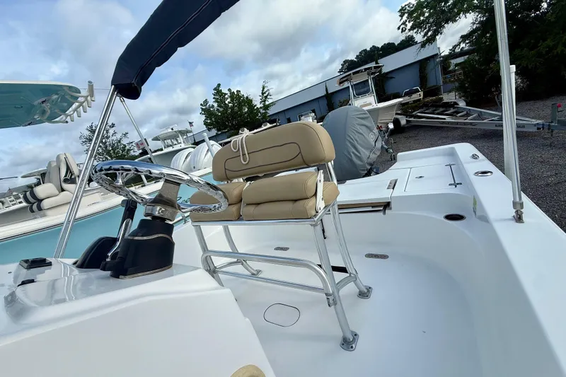 Slide: The Image of 2015 Sportsman Masters 227 Bay Boat with helm and seating, docked outdoors. - 7