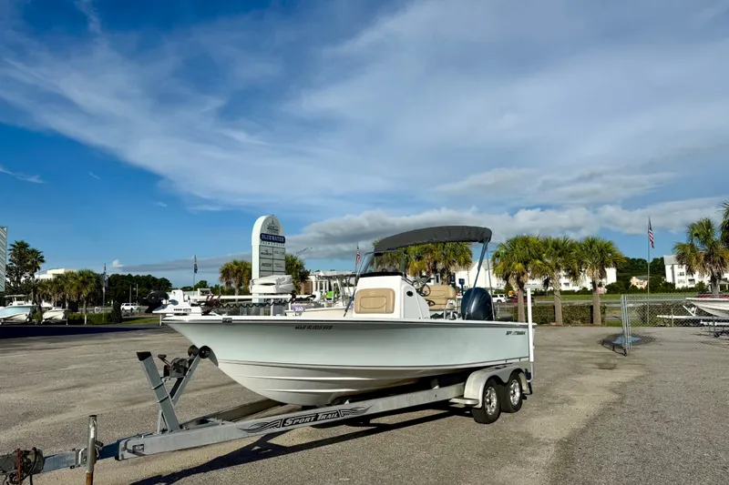 Slide: The Image of 2015 Sportsman Masters 227 Bay Boat on trailer, parked outdoors under a clear sky. - 4