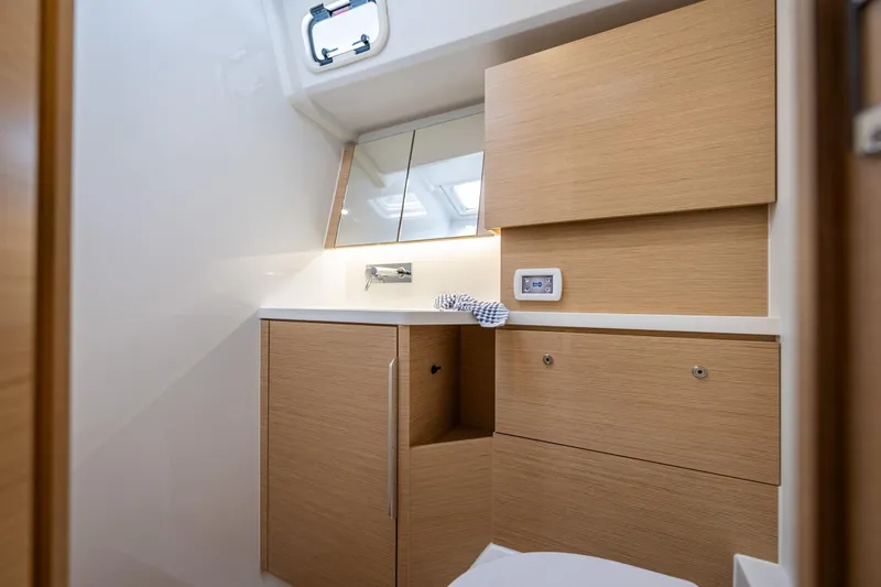Slide: The Image of Modern bathroom interior on 2025 Hanse 460 yacht, featuring sleek wooden cabinetry. - 29