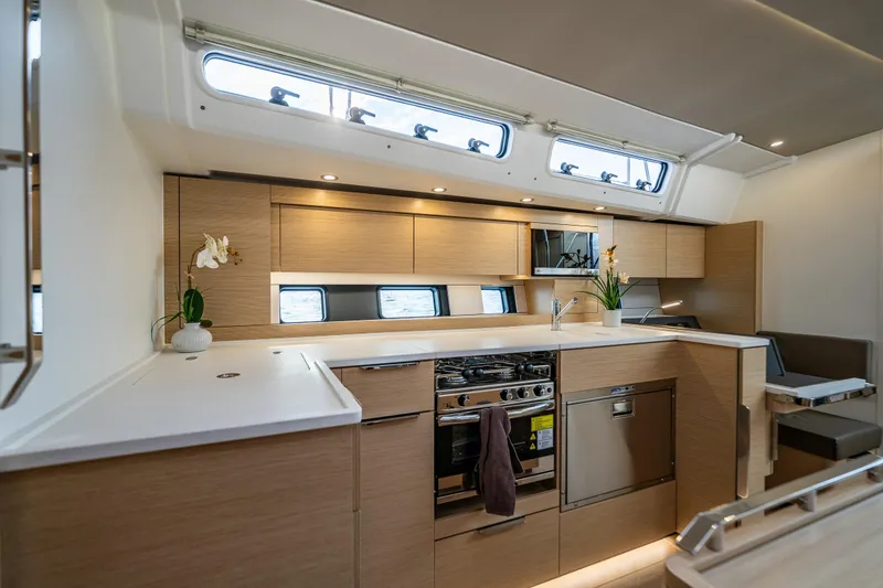 Slide: The Image of Modern kitchen interior of 2025 Hanse 460 yacht with sleek wood cabinetry and appliances. - 13