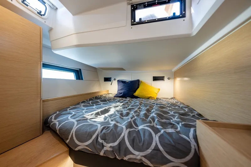Slide: The Image of Cozy cabin interior of 2025 Hanse 460 yacht with modern bedding and natural light. - 25