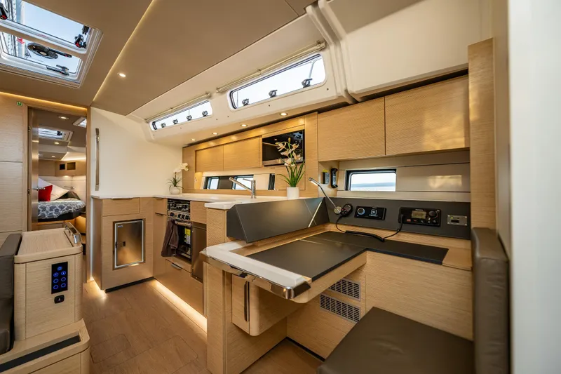 Slide: The Image of Luxurious interior of 2025 Hanse 460 yacht with modern kitchen and cozy seating area. - 15