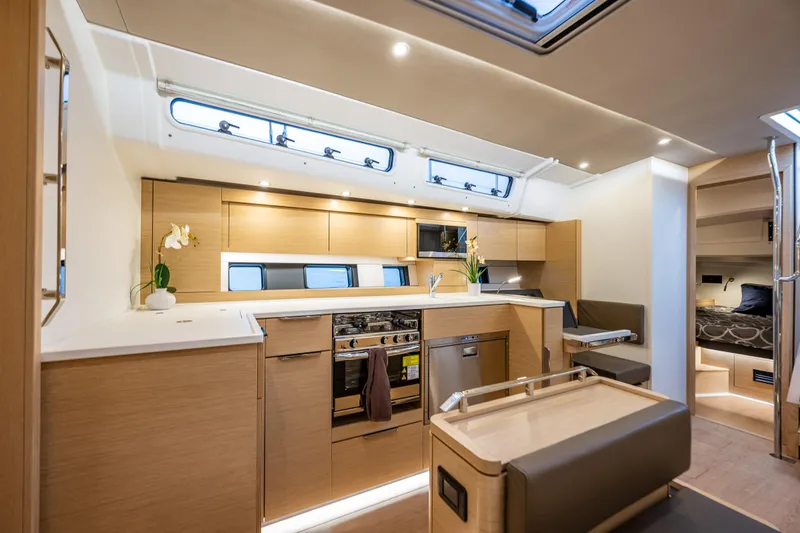 Slide: The Image of Luxurious interior of 2025 Hanse 460 yacht with modern kitchen and cozy seating area. - 14