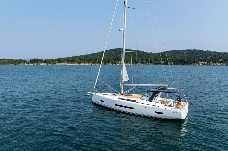 Slide: The Image of Sailing yacht Hanse 460 (2025) on calm waters near a forested shoreline. - 4