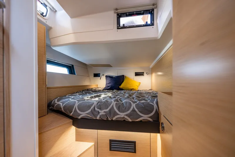 Slide: The Image of 2025 Hanse 460 yacht cabin with cozy bed, modern design, and natural light. - 27