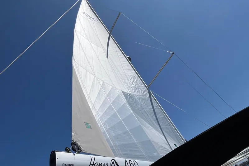 Slide: The Image of Sailing yacht Hanse 460, 2025 model, with sails unfurled against a clear blue sky. - 40