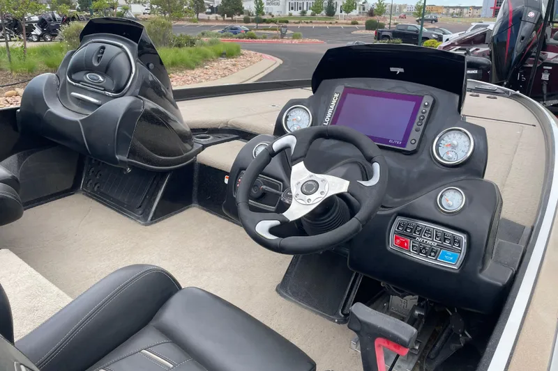 Slide: The Image of 2016 Nitro Z21 boat cockpit with steering wheel, gauges, and control panel. - 2