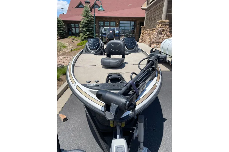 Slide: The Image of 2016 Nitro Z21 fishing boat parked near a rustic building. - 5