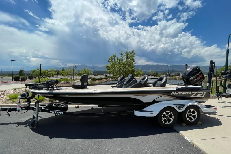 Slide: The Image of 2016 Nitro Z21 boat on trailer under a partly cloudy sky. - 6