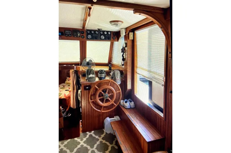 Slide: The Image of 1987 Senator-Chien Hwa Futura Sundeck interior with wooden helm and nautical decor. - 17