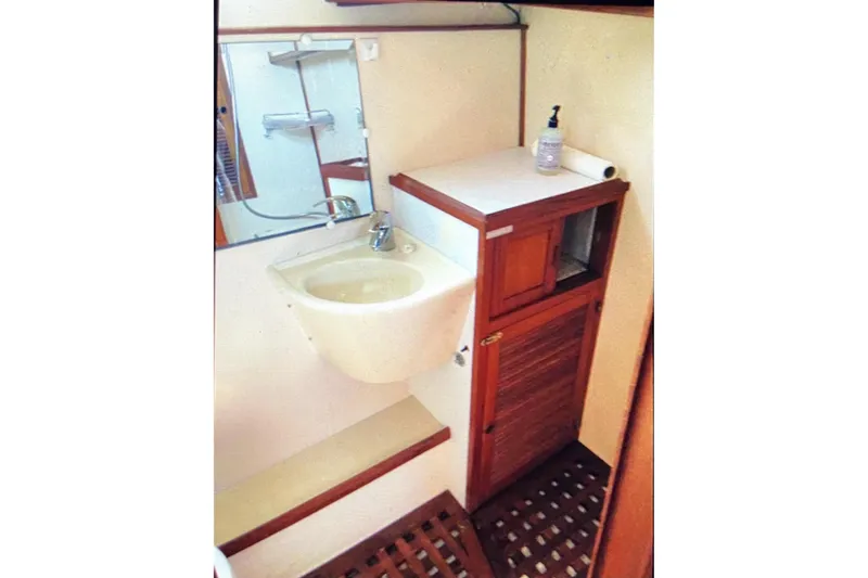 Slide: The Image of 1987 Senator-Chien Hwa Futura Sundeck bathroom with sink, mirror, and wooden cabinetry. - 22